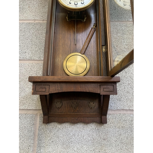 38 - An early/mid 20th century oak chiming wall clock - approx. 88cm high x 31cm wide