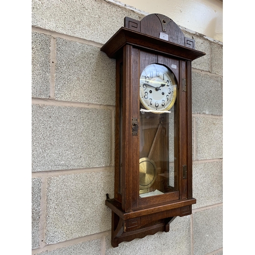 38 - An early/mid 20th century oak chiming wall clock - approx. 88cm high x 31cm wide