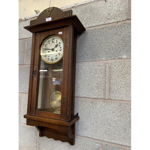 38 - An early/mid 20th century oak chiming wall clock - approx. 88cm high x 31cm wide