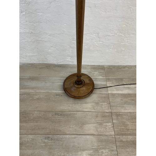 39 - A 20th century mahogany tapered standard lamp with white tasseled shade - approx. 160cm high (exclud... 