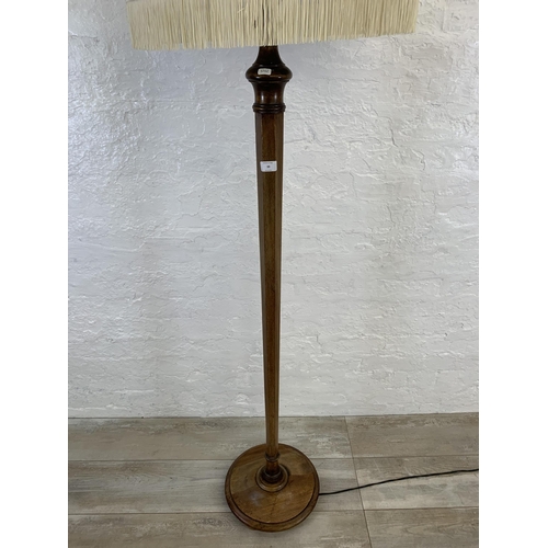 39 - A 20th century mahogany tapered standard lamp with white tasseled shade - approx. 160cm high (exclud... 