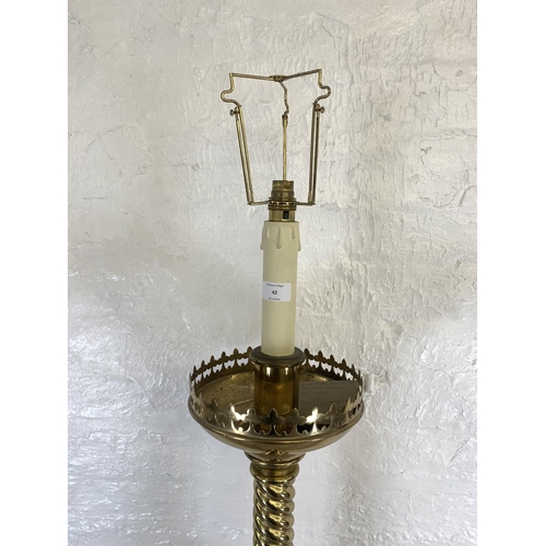 42 - A 19th century Gothic Revival ecclesiastical converted electric standard lamp on lion paw feet, step... 