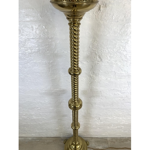 42 - A 19th century Gothic Revival ecclesiastical converted electric standard lamp on lion paw feet, step... 