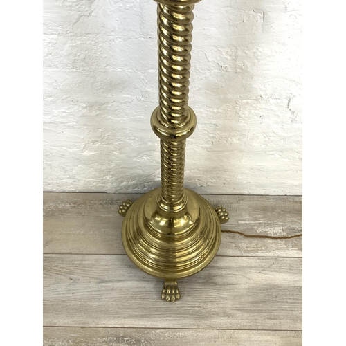 42 - A 19th century Gothic Revival ecclesiastical converted electric standard lamp on lion paw feet, step... 