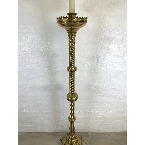 45 - A 19th century Gothic Revival ecclesiastical converted electric standard lamp on lion paw feet, step... 