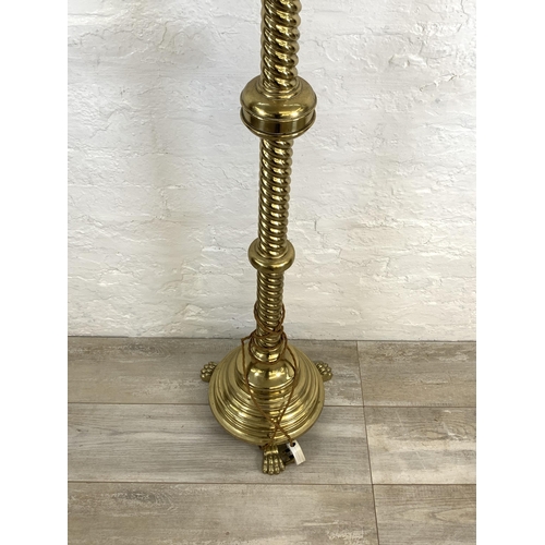 45 - A 19th century Gothic Revival ecclesiastical converted electric standard lamp on lion paw feet, step... 