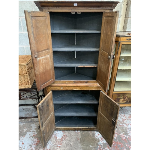 50 - A Victorian scrumbled pine free-standing corner cabinet - approx. 201cm high x 96cm wide