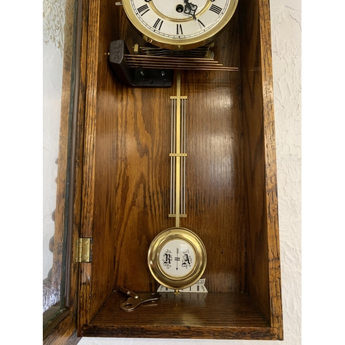 53 - A vintage Emperor Westminster chime oak wall clock - approx. 77cm high