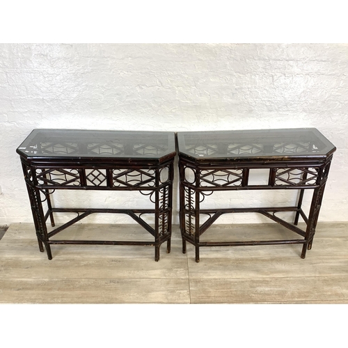 54 - A pair of vintage bamboo and glass topped console tables - approx. 81cm high x 96cm wide x 42cm deep