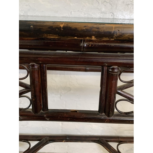 54 - A pair of vintage bamboo and glass topped console tables - approx. 81cm high x 96cm wide x 42cm deep