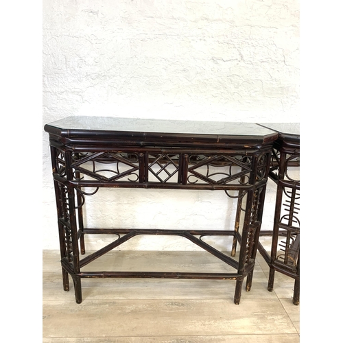 54 - A pair of vintage bamboo and glass topped console tables - approx. 81cm high x 96cm wide x 42cm deep