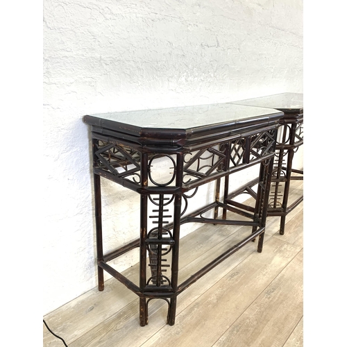 54 - A pair of vintage bamboo and glass topped console tables - approx. 81cm high x 96cm wide x 42cm deep