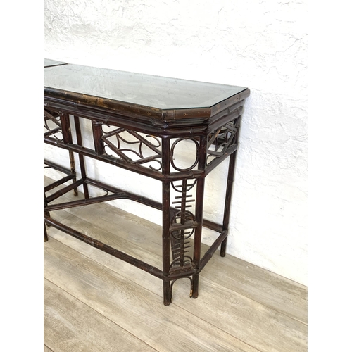 54 - A pair of vintage bamboo and glass topped console tables - approx. 81cm high x 96cm wide x 42cm deep