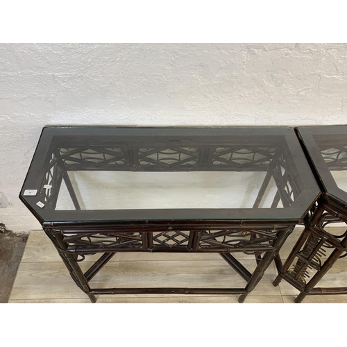 54 - A pair of vintage bamboo and glass topped console tables - approx. 81cm high x 96cm wide x 42cm deep