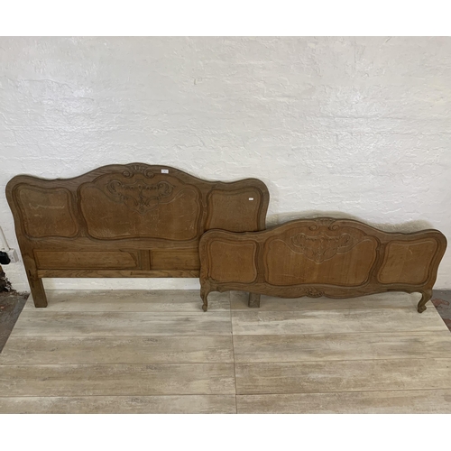 55 - A French Louis XV style oak double bed headboard and footboard