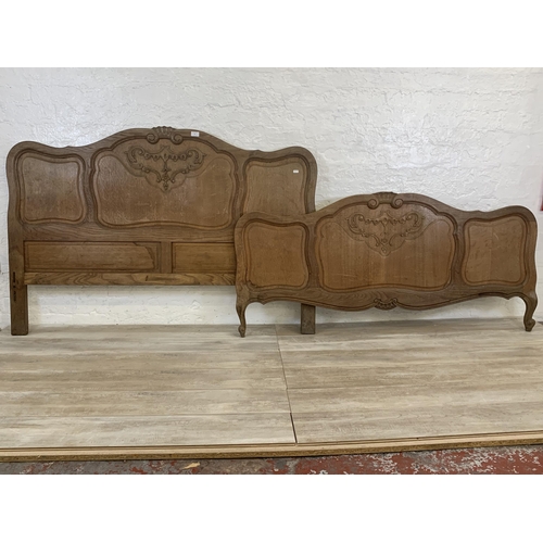 55 - A French Louis XV style oak double bed headboard and footboard