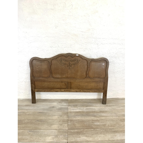 55 - A French Louis XV style oak double bed headboard and footboard