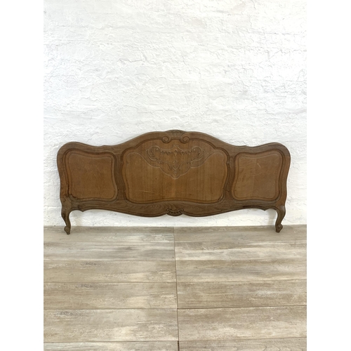 55 - A French Louis XV style oak double bed headboard and footboard