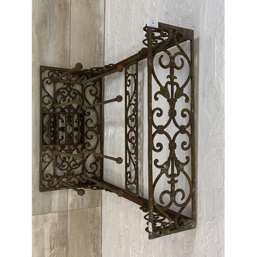 56 - A Victorian style cast iron boot rack with scraper - approx. 75cm high x 63cm wide x 33cm deep