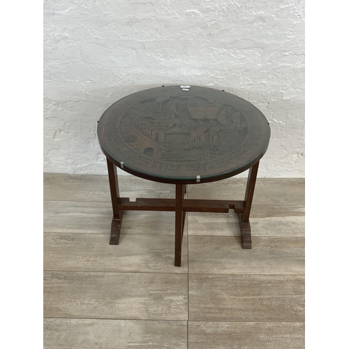 59 - A Chinese carved hardwood circular folding occasional table