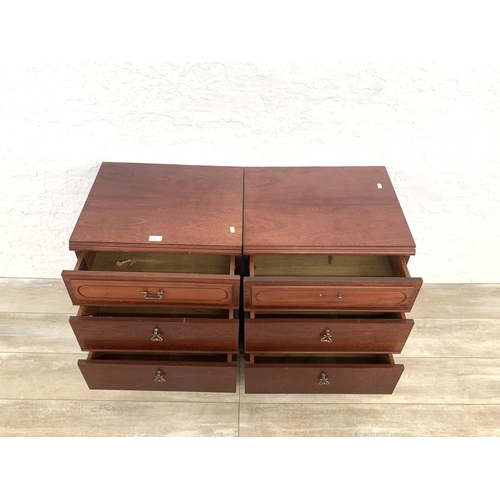 60 - A pair of 1980s mahogany bedside chests of three drawers - approx. 67cm high x 51cm wide x 42cm deep