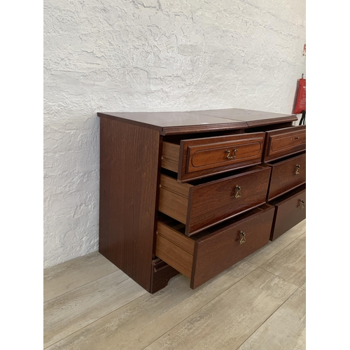 60 - A pair of 1980s mahogany bedside chests of three drawers - approx. 67cm high x 51cm wide x 42cm deep