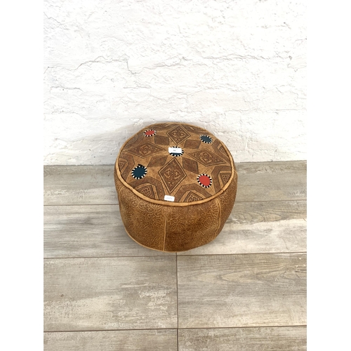 61 - A vintage Moroccan brown leather circular footstool