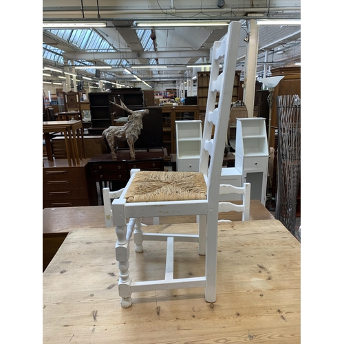 65 - A Victorian style white painted pine farmhouse dining table with four ladderback rush seated dining ... 