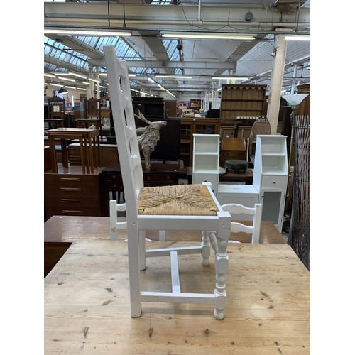 65 - A Victorian style white painted pine farmhouse dining table with four ladderback rush seated dining ... 