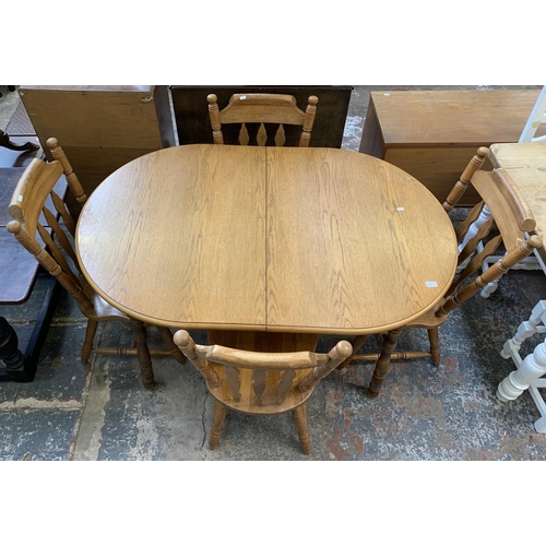 67 - A oak extending dining table with four oak farmhouse dining chairs