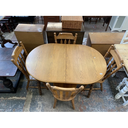 67 - A oak extending dining table with four oak farmhouse dining chairs