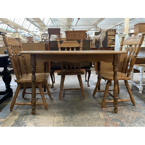 67 - A oak extending dining table with four oak farmhouse dining chairs