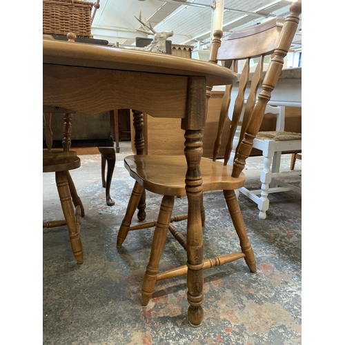 67 - A oak extending dining table with four oak farmhouse dining chairs