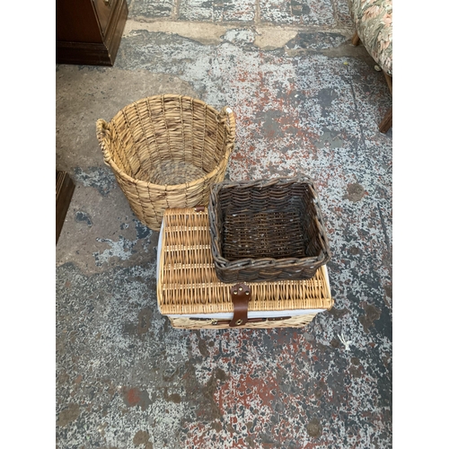 8 - Ten pieces of wicker furniture and baskets to include 1970s tub chair, picnic basket, twin handled b... 