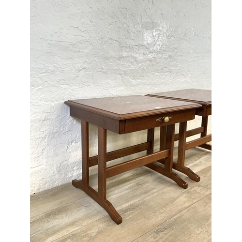 82 - A pair of stained mahogany bedside tables - approx. 52cm high x 57cm wide x 51cm deep