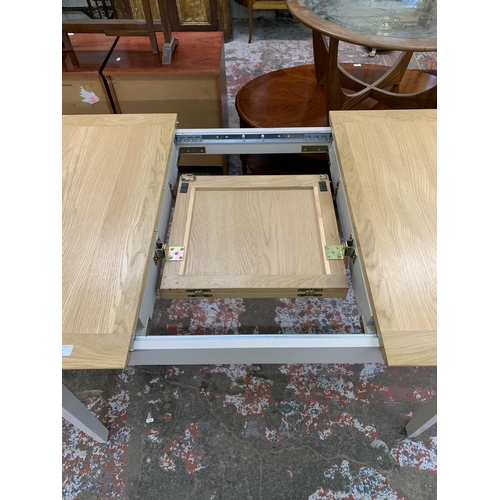 83 - An Arighi Bianchi oak and grey painted extending dining table - approx. 79cm high x 120cm long x 85c... 