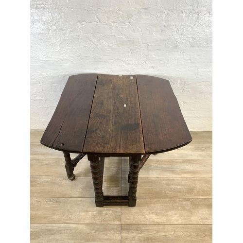 84 - An 18th century oak gate leg drop leaf dining table on bobbin supports