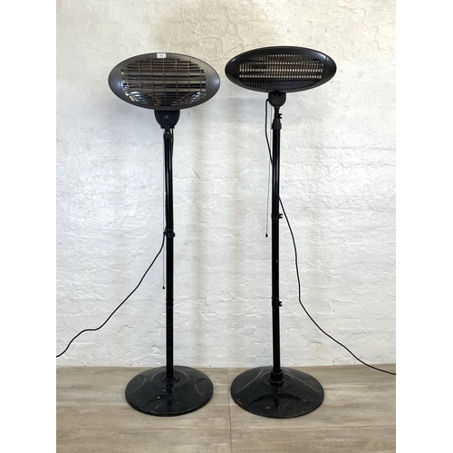 98 - Two black metal floor standing electric heaters