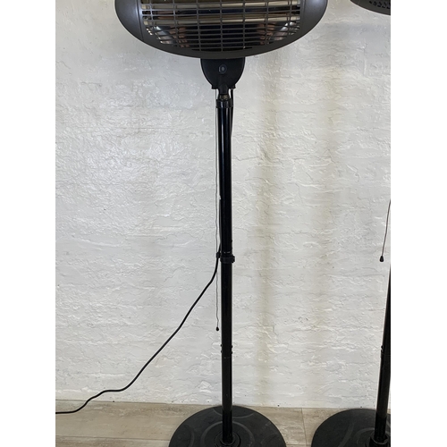 98 - Two black metal floor standing electric heaters