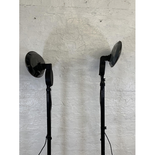 98 - Two black metal floor standing electric heaters