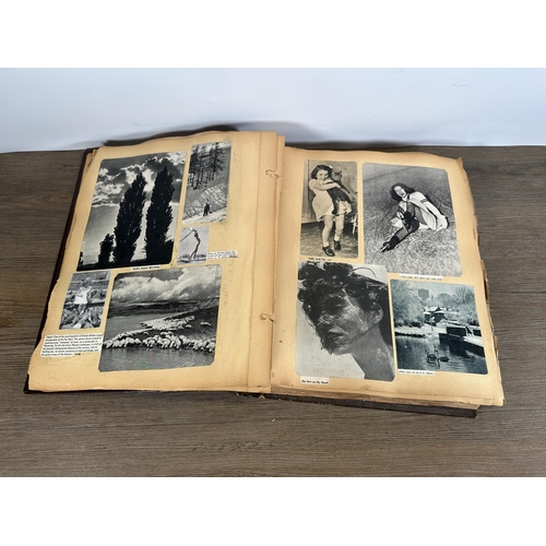 553 - A vintage scrapbook containing a collection of newspaper, magazine and book cuttings