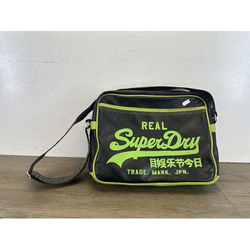 534 - A SuperDry black and green leatherette messenger bag