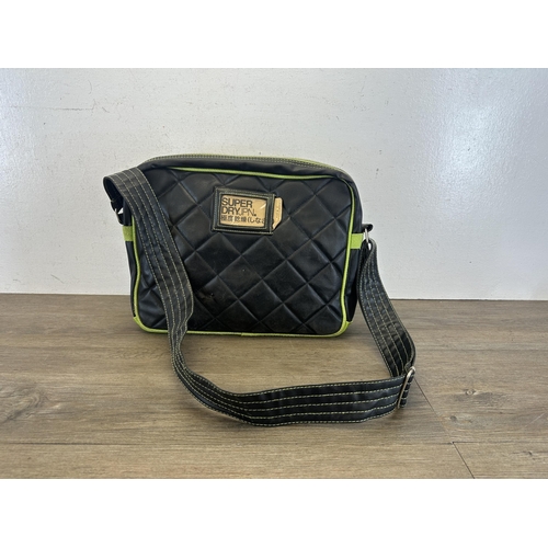 534 - A SuperDry black and green leatherette messenger bag