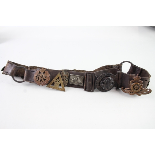 2319 - A vintage Boy Scouts brown leather Belt complete with badges to include military cap badges, His Mas... 