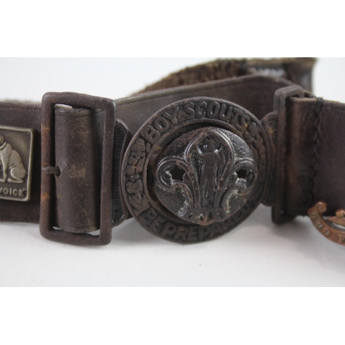 2319 - A vintage Boy Scouts brown leather Belt complete with badges to include military cap badges, His Mas... 