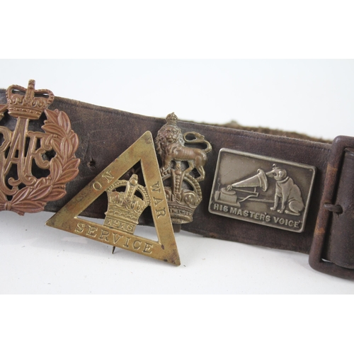 2319 - A vintage Boy Scouts brown leather Belt complete with badges to include military cap badges, His Mas... 