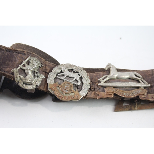 2319 - A vintage Boy Scouts brown leather Belt complete with badges to include military cap badges, His Mas... 