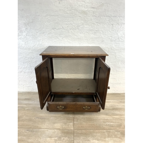 125 - A Titchmarsh & Goodwin style oak television cabinet - approx. 87cm high x 81cm wide x 48cm deep