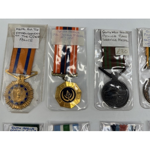 2340 - Fifteen South African military and police medals to include Good Service, Defence Force 20 Years Ser... 