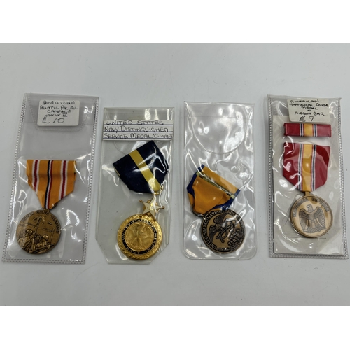 2353 - Four United States of America military medals to include Navy Service, National Defence etc.